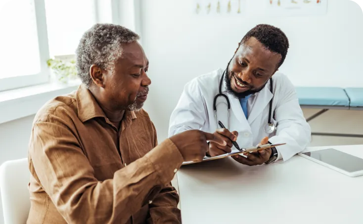 Actor portrayal of a black man speaking with a doctor about prostate cancer and treatment.